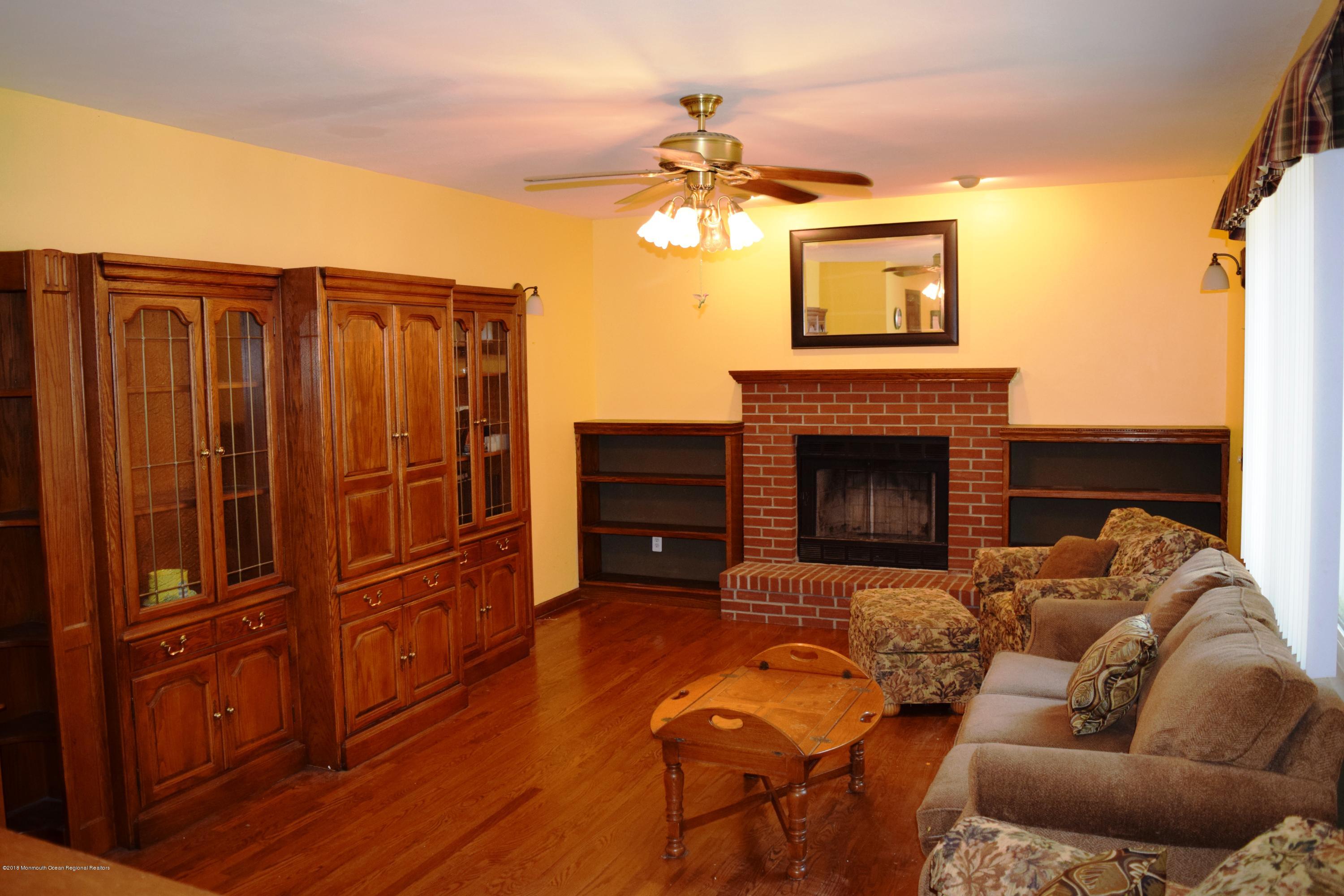 17 Dunhill Road Jackson, NJ 08527 - Photo 8 of 28 a living room with furniture a fireplace and a flat screen tv