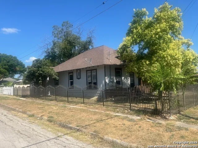 a backyard of a house with table and chairs