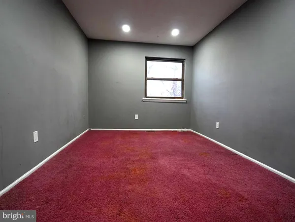 an empty room with a fan