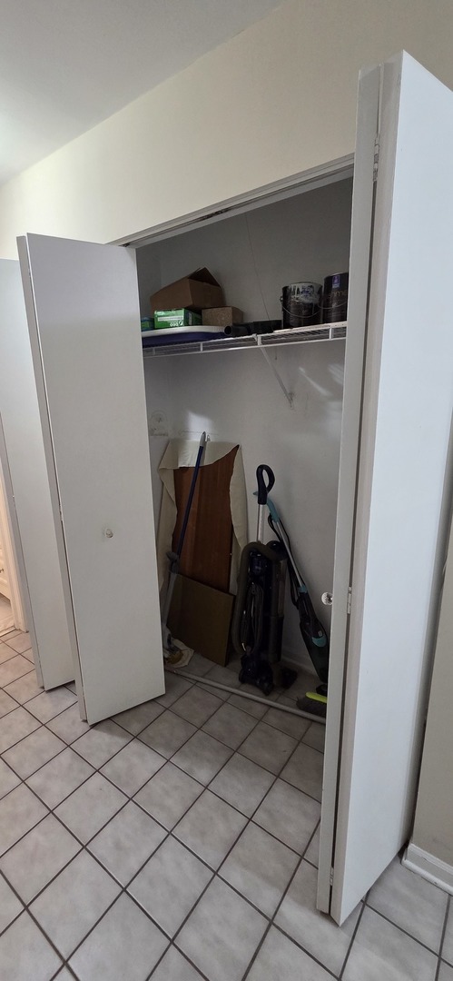 450 Raintree Court, Unit 2M Glen Ellyn, IL 60137 - Photo 12 of 25 a view of walk in closet with clothes and shoes