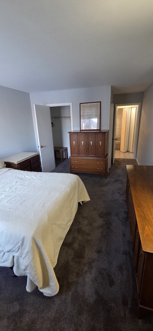 450 Raintree Court, Unit 2M Glen Ellyn, IL 60137 - Photo 15 of 25 a bedroom with a bed and window