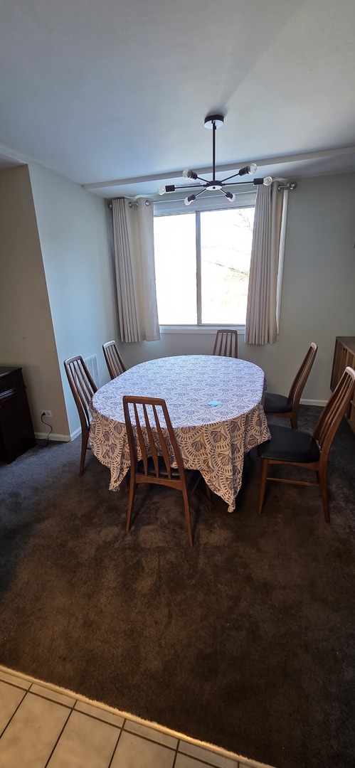 450 Raintree Court, Unit 2M Glen Ellyn, IL 60137 - Photo 22 of 25 a bed sitting in a bedroom next to a window