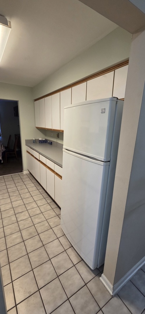 450 Raintree Court, Unit 2M Glen Ellyn, IL 60137 - Photo 25 of 25 a kitchen with stainless steel appliances granite countertop a refrigerator and a stove top oven