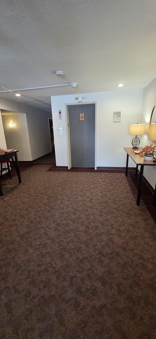 450 Raintree Court, Unit 2M Glen Ellyn, IL 60137 - Photo 3 of 25 a view of a room with gym equipment