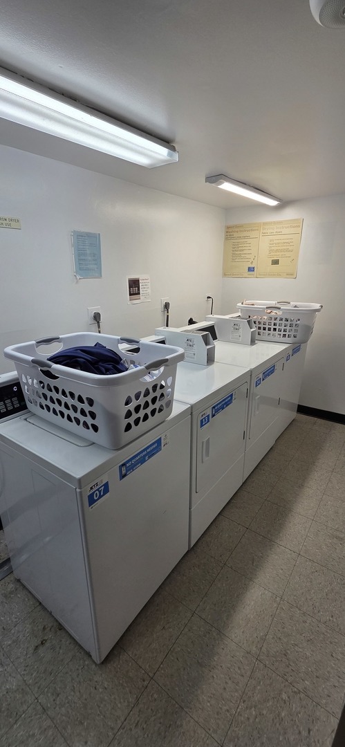 450 Raintree Court, Unit 2M Glen Ellyn, IL 60137 - Photo 6 of 25 a kitchen with stainless steel appliances a stove a sink and a microwave