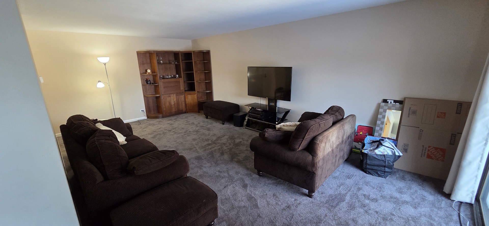450 Raintree Court, Unit 2M Glen Ellyn, IL 60137 - Photo 9 of 25 a living room with furniture and a flat screen tv