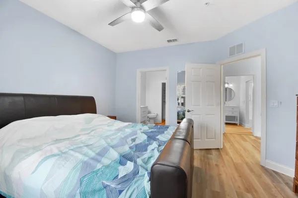 a bedroom with a bed and a chandelier