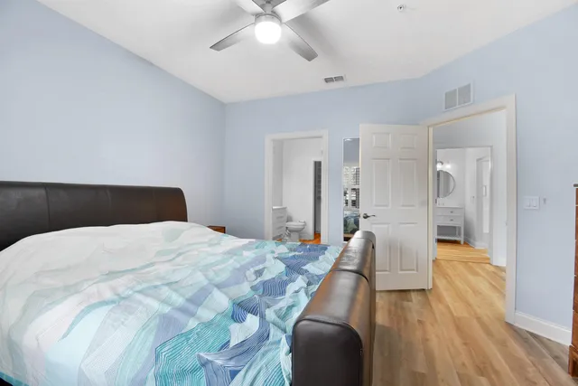 a bedroom with a bed and a chandelier