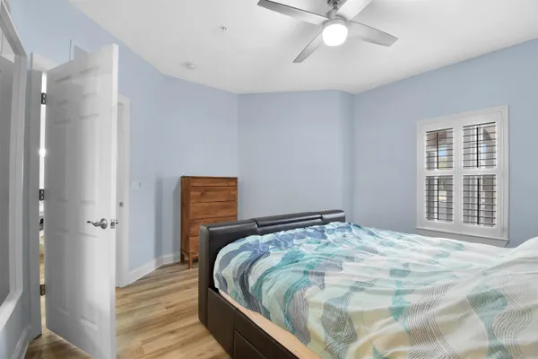 a bedroom with a bed and a chandelier