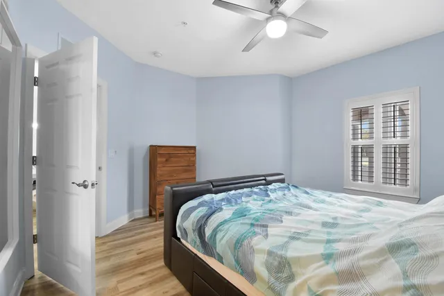 a bedroom with a bed and a chandelier