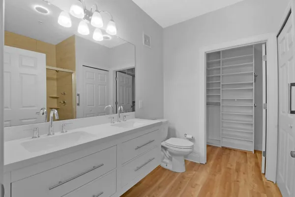 a bathroom with a double vanity sink mirror and toilet
