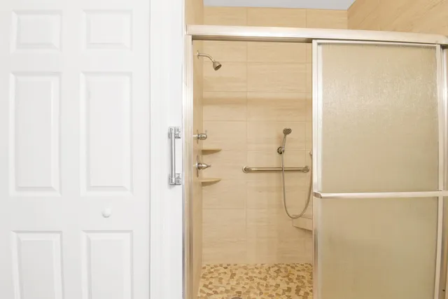 a bathroom with a glass shower door