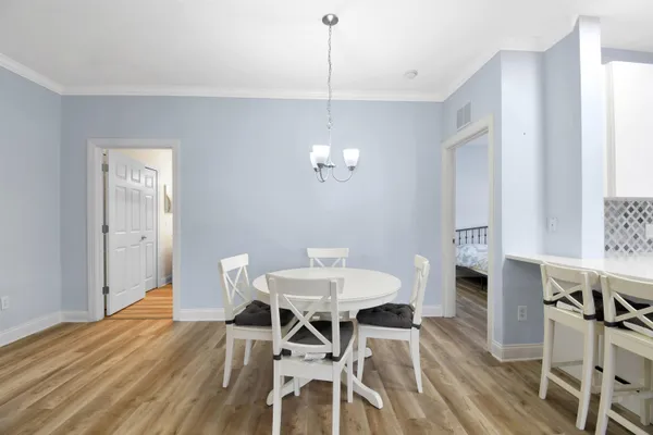 a view of a dining room with furniture and wooden floor