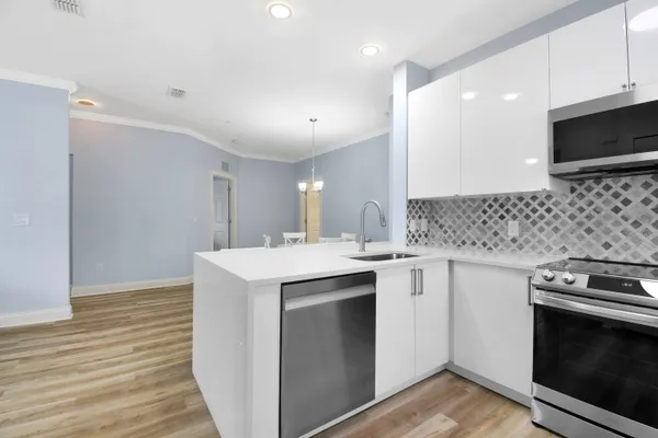 a kitchen with a sink stove and microwave