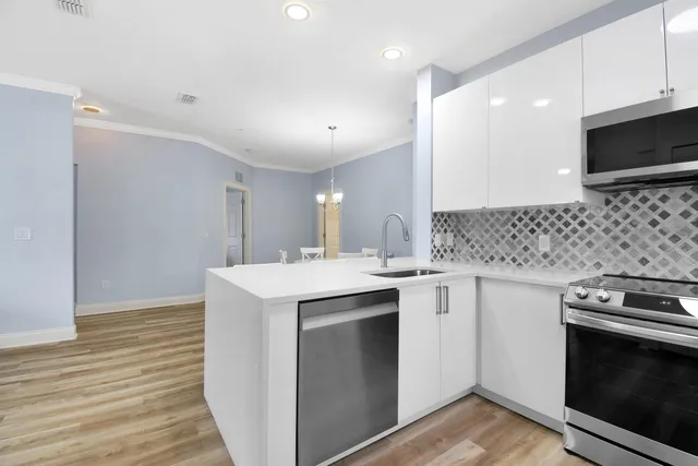 a kitchen with a sink stove and microwave