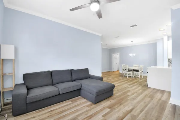 a living room with furniture and a wooden floor