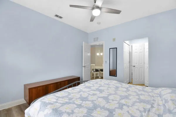 a bedroom with a bed and a chandelier