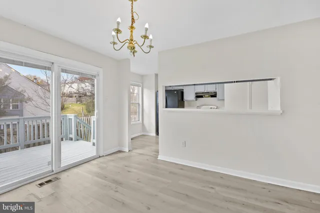 a view of a big room with wooden floor and windows