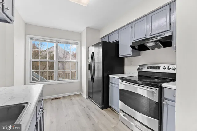 a kitchen with stainless steel appliances a stove a microwave and a refrigerator