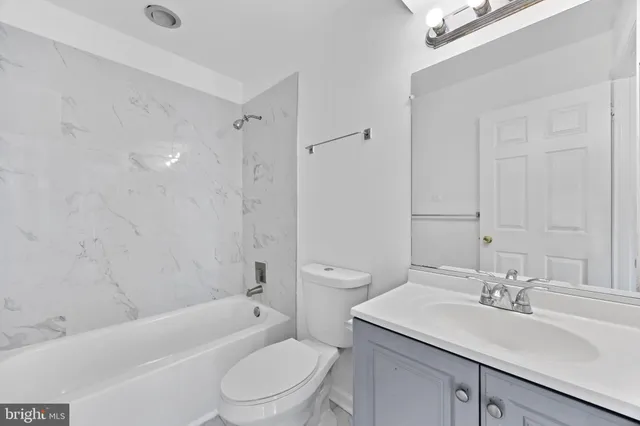 a bathroom with a sink toilet vanity and shower