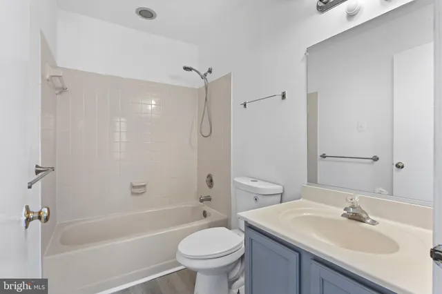 a bathroom with a sink toilet tub vanity and shower