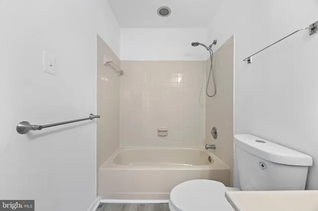 a bathroom with a toilet and a bath tub