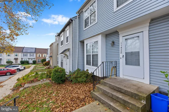 a view of a brick house with many windows
