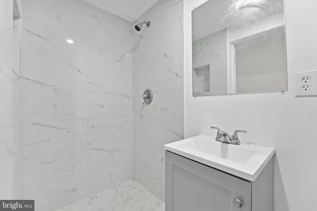 a bathroom with a sink toilet a vanity and shower