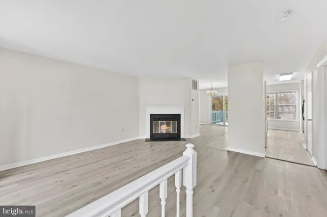 a view of a kitchen with a sink and a fireplace