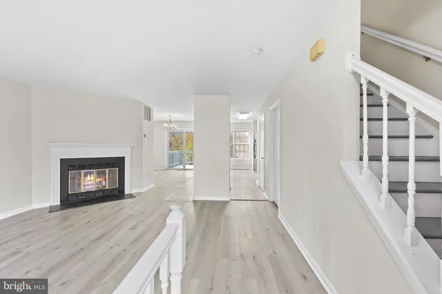 a view of a hallway with wooden floor and a fireplace