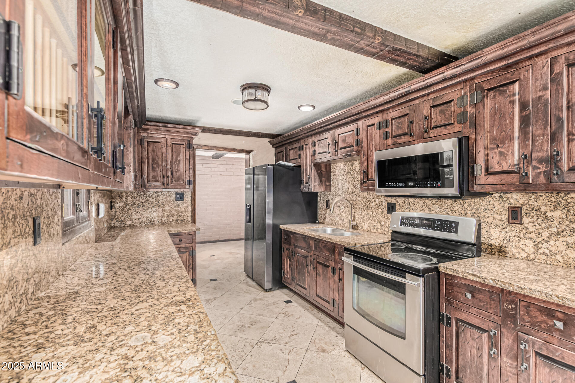 3812 West Thomas Road Phoenix, AZ 85019 - Photo 14 of 35 a kitchen with stainless steel appliances kitchen island granite countertop a stove and a sink