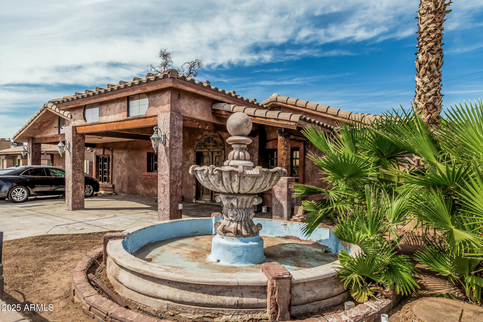 3812 West Thomas Road Phoenix, AZ 85019 - Photo 5 of 35 a view of a house with a fountain in a yard