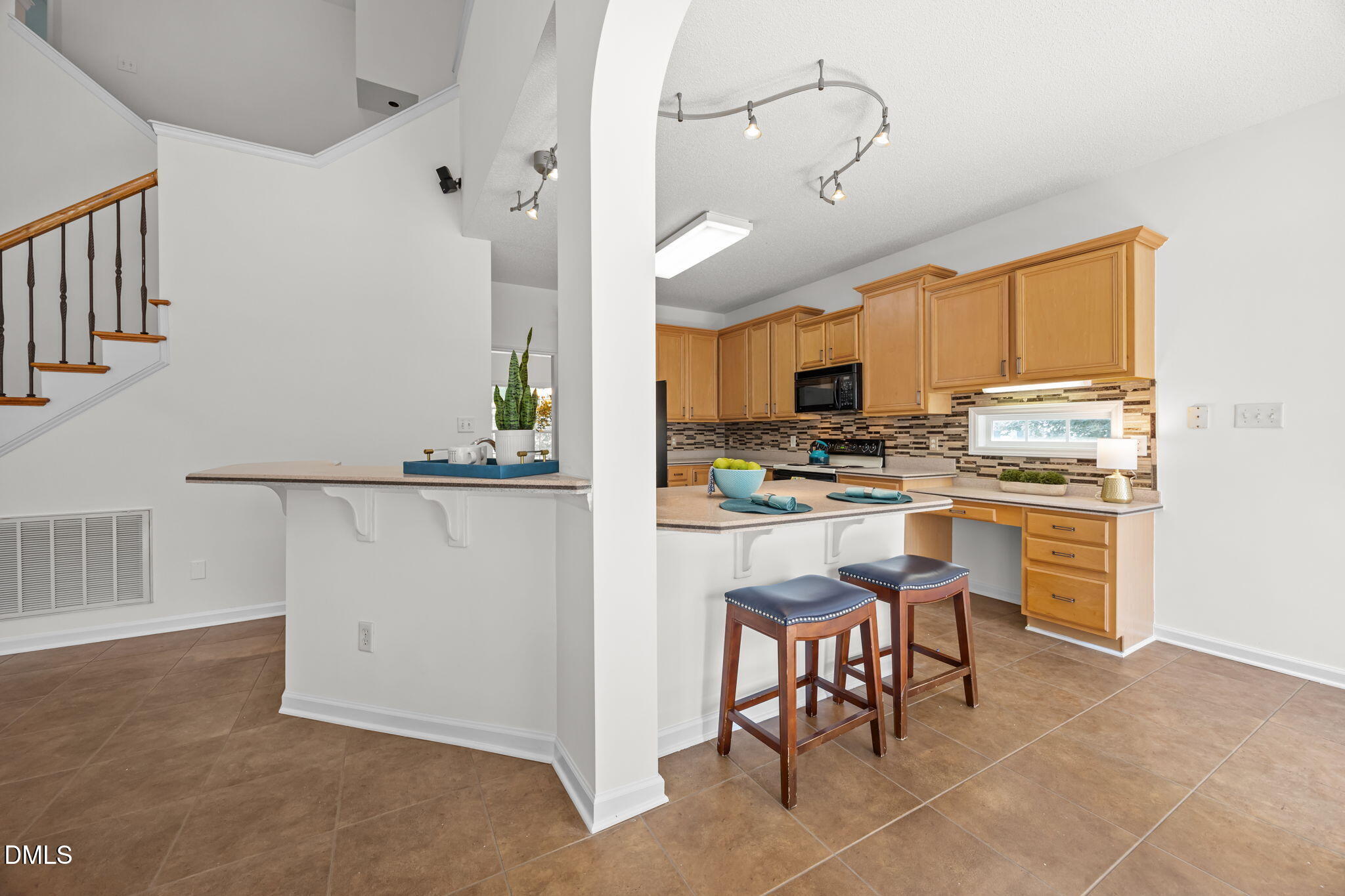 5501 Southern Cross Avenue Raleigh, NC 27606 - Photo 13 of 43 a kitchen with kitchen island granite countertop counter top space appliances and a cabinets