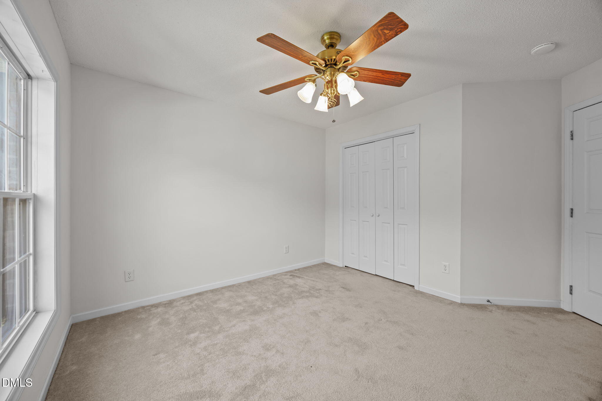 5501 Southern Cross Avenue Raleigh, NC 27606 - Photo 27 of 43 an empty room with a window and a chandelier fan