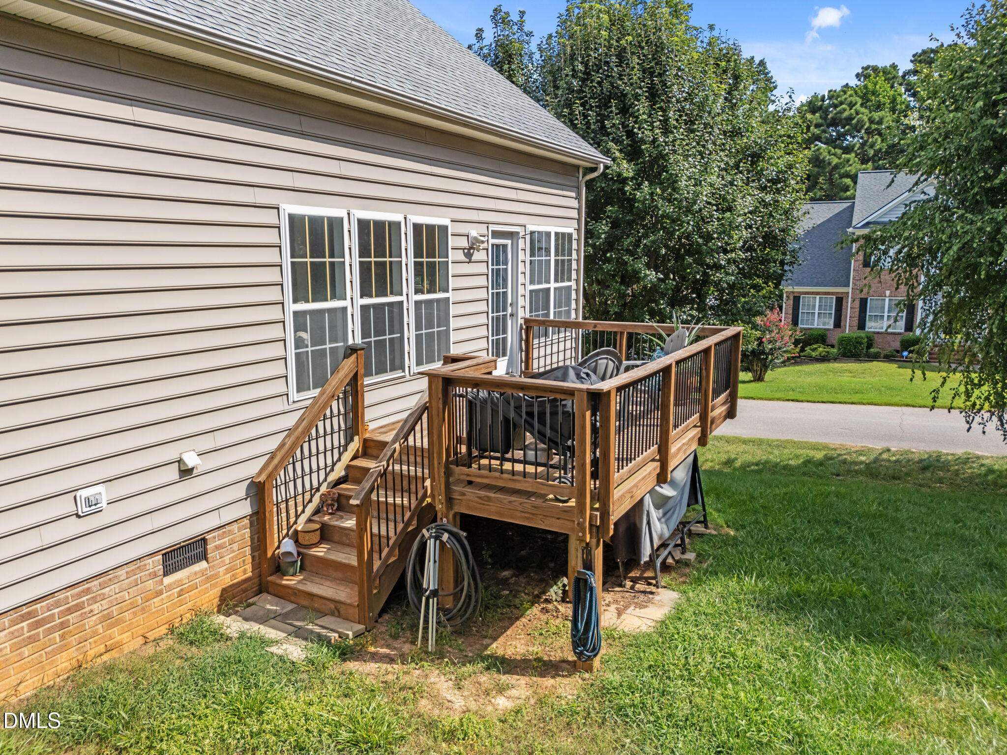 5501 Southern Cross Avenue Raleigh, NC 27606 - Photo 35 of 43 a view of a house with a deck and a yard