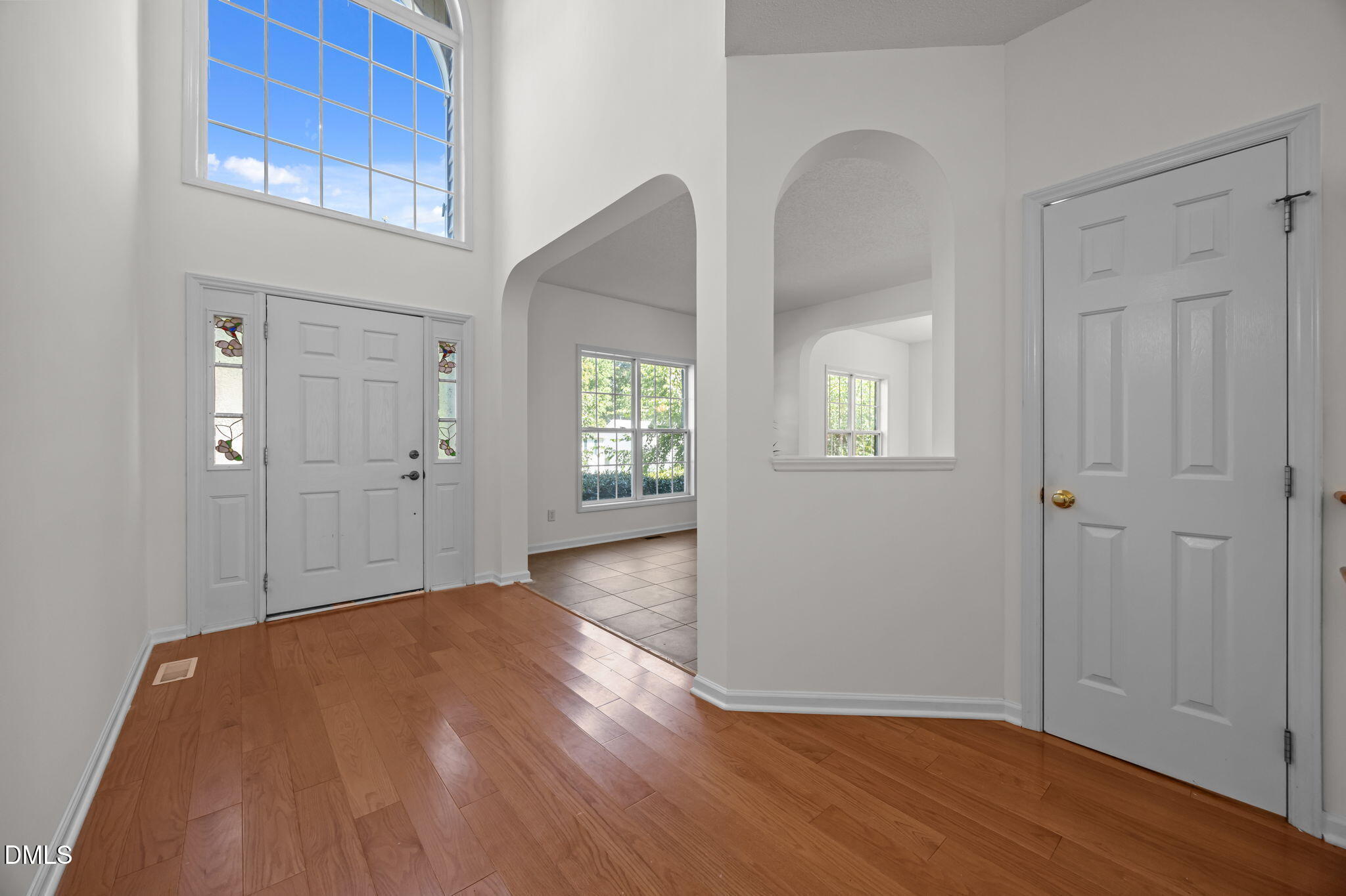 5501 Southern Cross Avenue Raleigh, NC 27606 - Photo 5 of 43 an empty room with wooden floor closet and windows