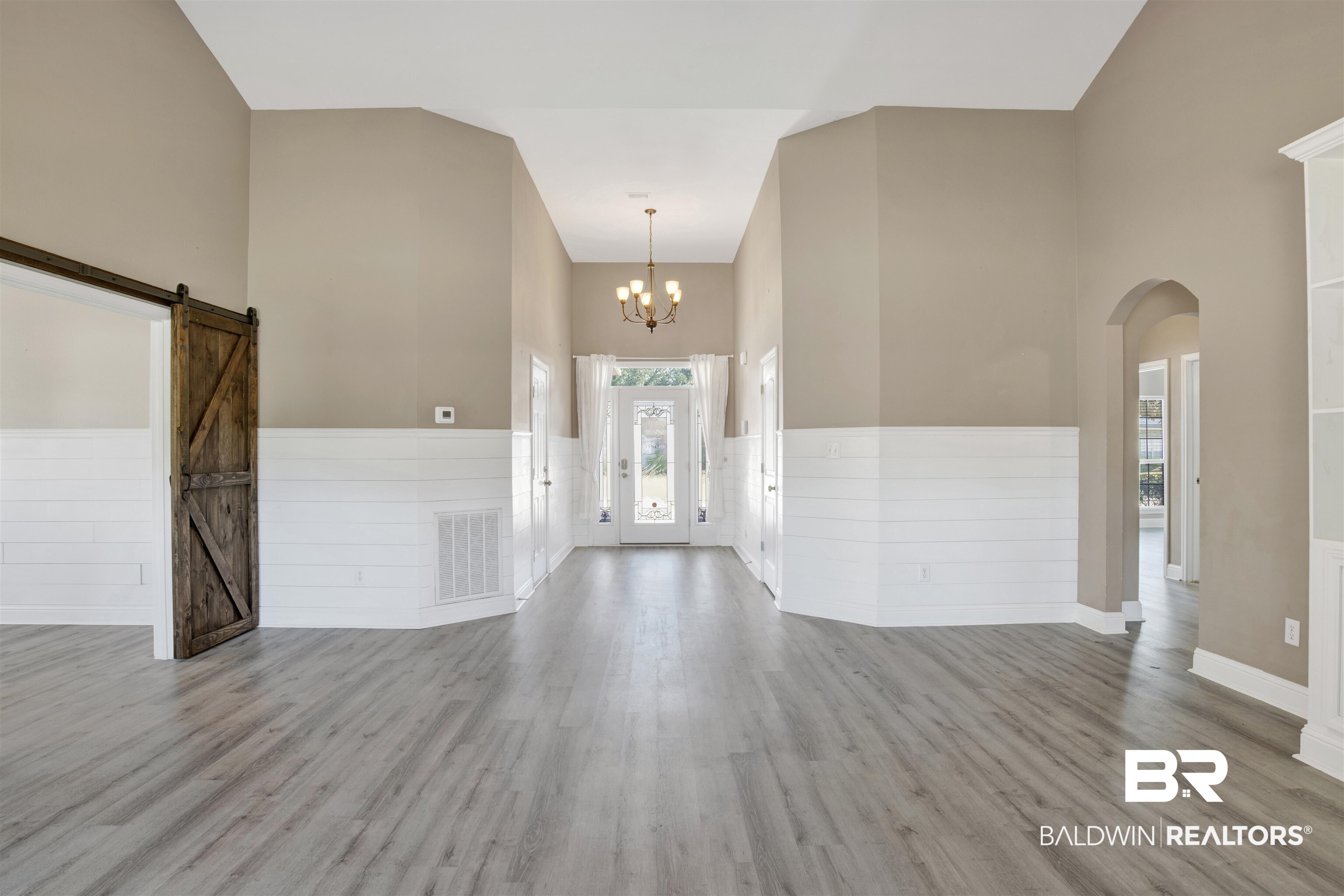 24159 Tullamore Drive Daphne, AL 36526 - Photo 5 of 31 Entryway with light hardwood / wood-style floors, a barn door, high vaulted ceiling, and a chandelier