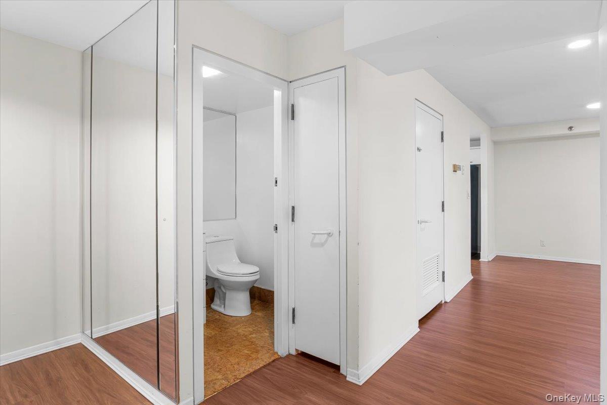 100 Cutter Mill Road, Unit 3F Great Neck, NY 11021 - Photo 11 of 33 a view of a bathroom with toilet shower and wooden floor