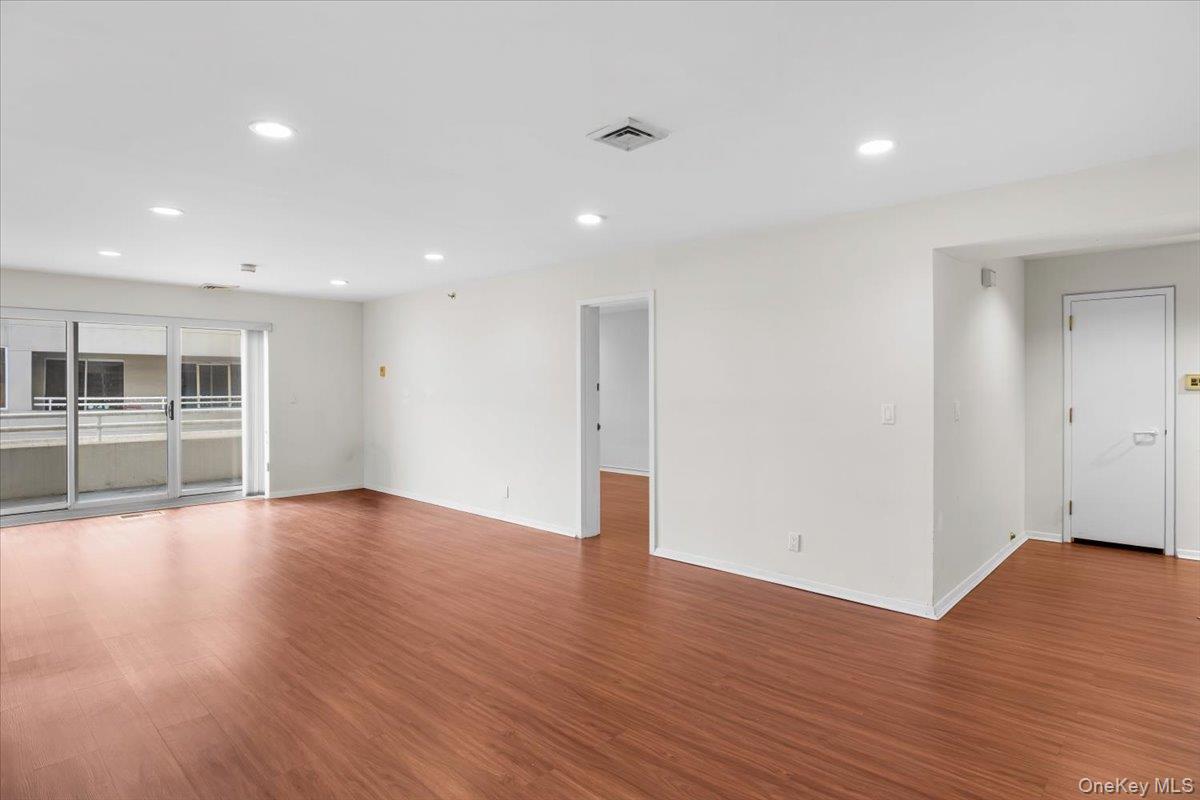 100 Cutter Mill Road, Unit 3F Great Neck, NY 11021 - Photo 14 of 33 a view of empty room with wooden floor
