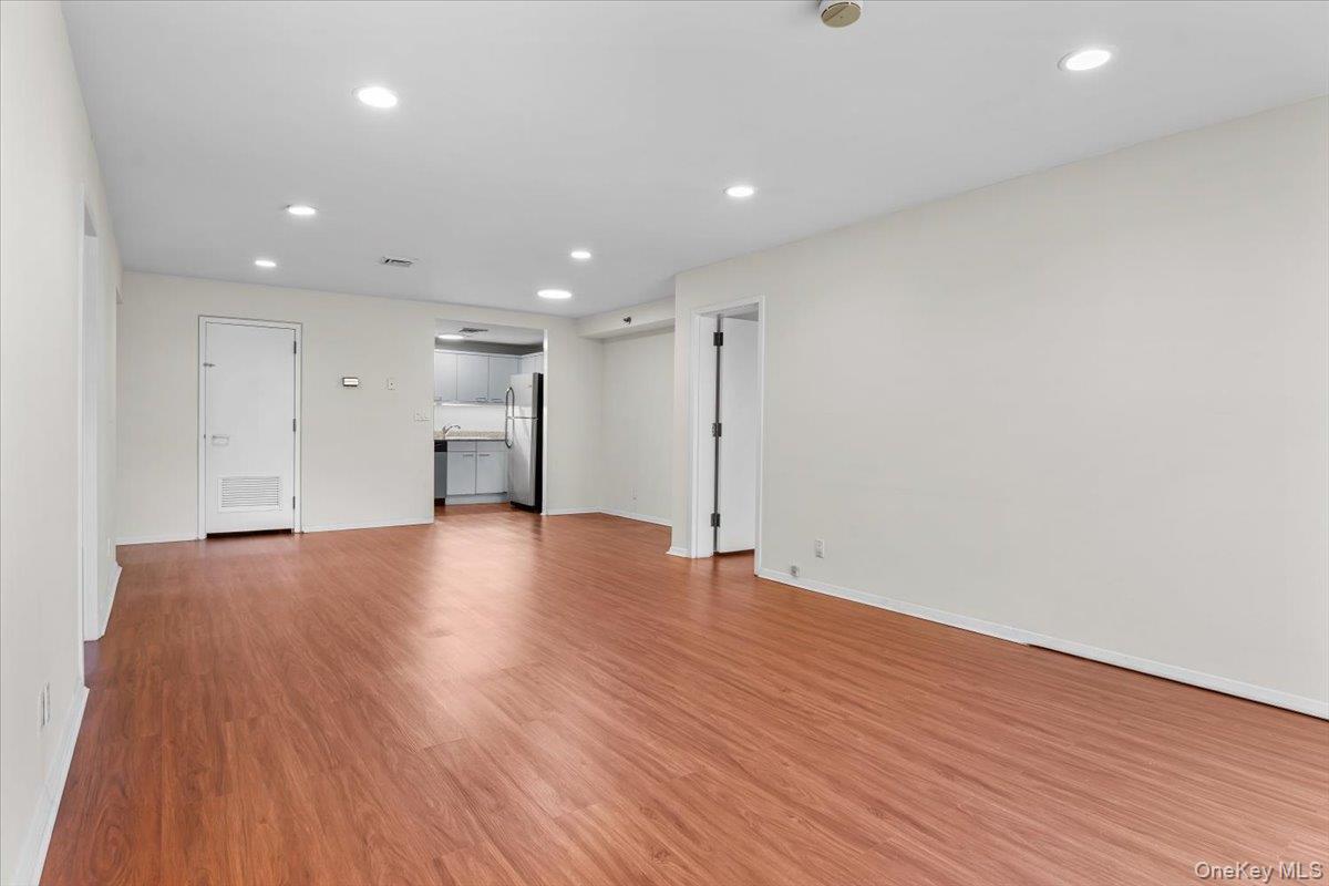 100 Cutter Mill Road, Unit 3F Great Neck, NY 11021 - Photo 17 of 33 a view of an empty room with wooden floor
