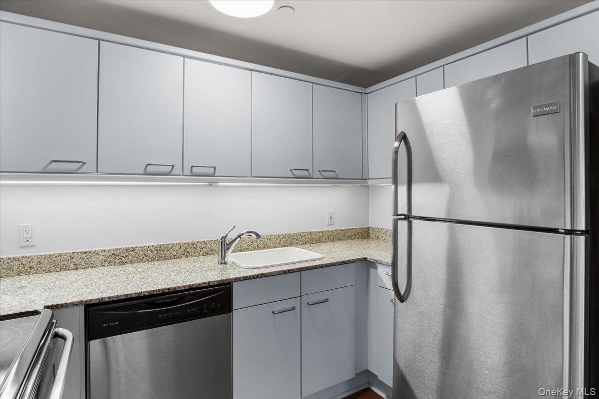 100 Cutter Mill Road, Unit 3F Great Neck, NY 11021 - Photo 21 of 33 a kitchen with a refrigerator and cabinets