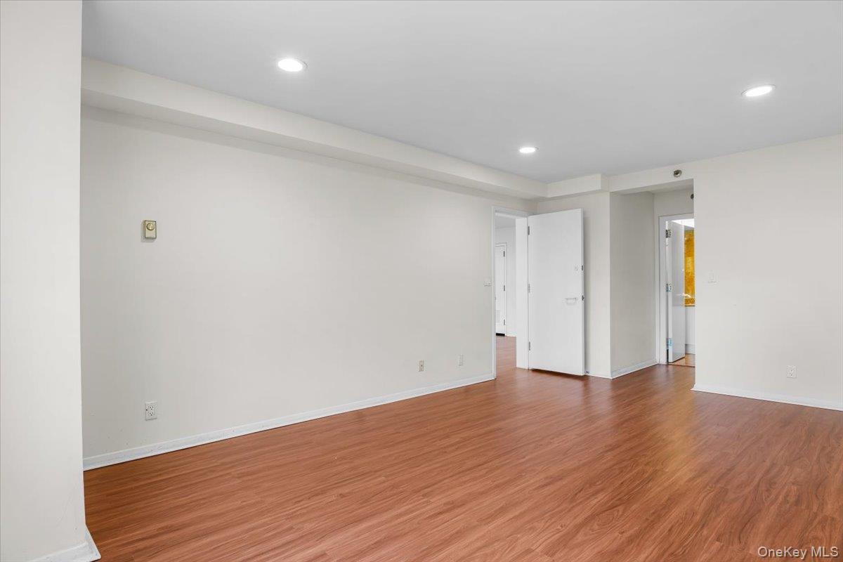 100 Cutter Mill Road, Unit 3F Great Neck, NY 11021 - Photo 23 of 33 a view of an empty room with wooden floor