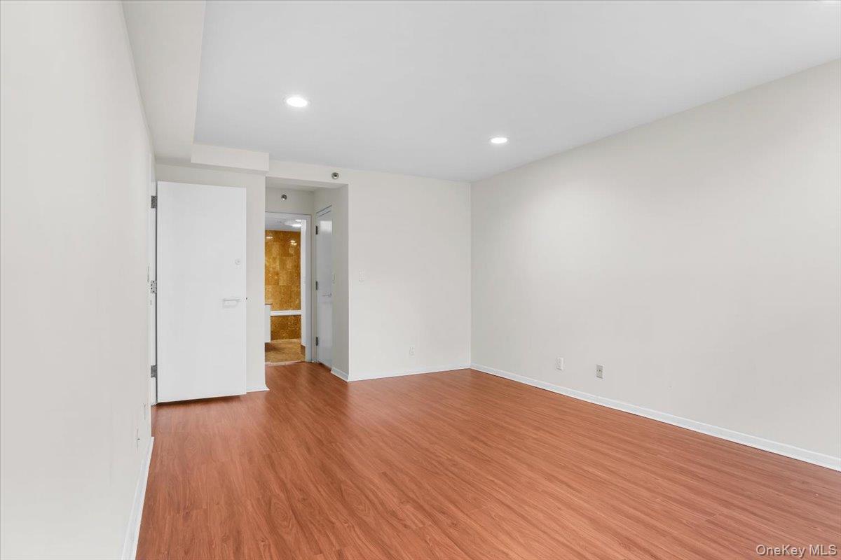 100 Cutter Mill Road, Unit 3F Great Neck, NY 11021 - Photo 24 of 33 a view of an empty room with wooden floor