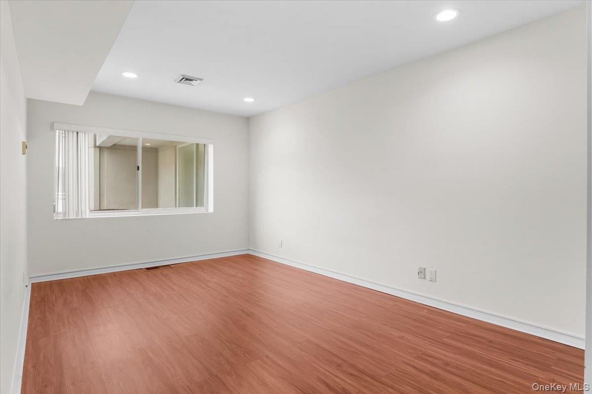 100 Cutter Mill Road, Unit 3F Great Neck, NY 11021 - Photo 28 of 33 a view of empty room with wooden floor and fan
