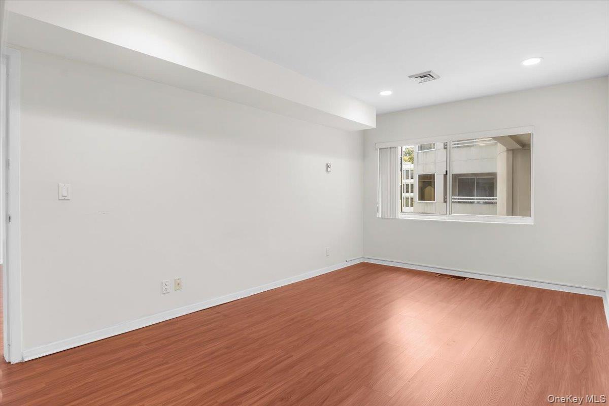 100 Cutter Mill Road, Unit 3F Great Neck, NY 11021 - Photo 29 of 33 a view of empty room with wooden floor and fan