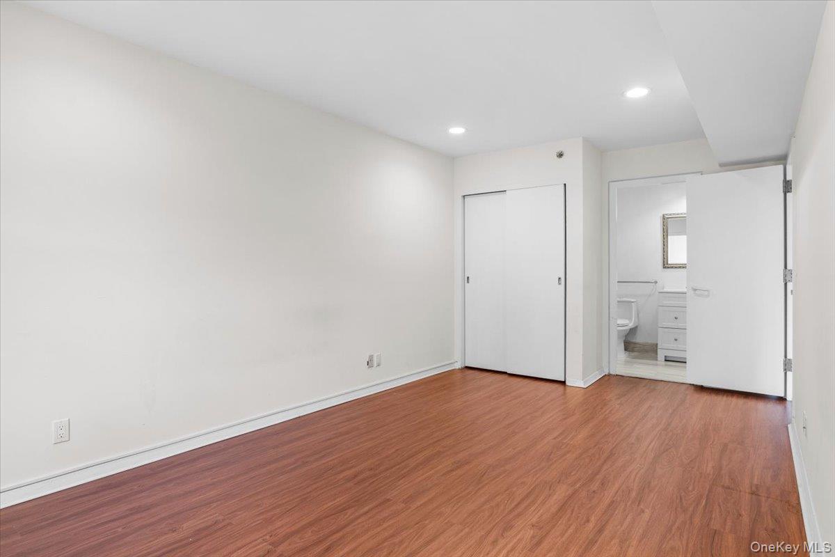 100 Cutter Mill Road, Unit 3F Great Neck, NY 11021 - Photo 31 of 33 a view of an empty room with wooden floor