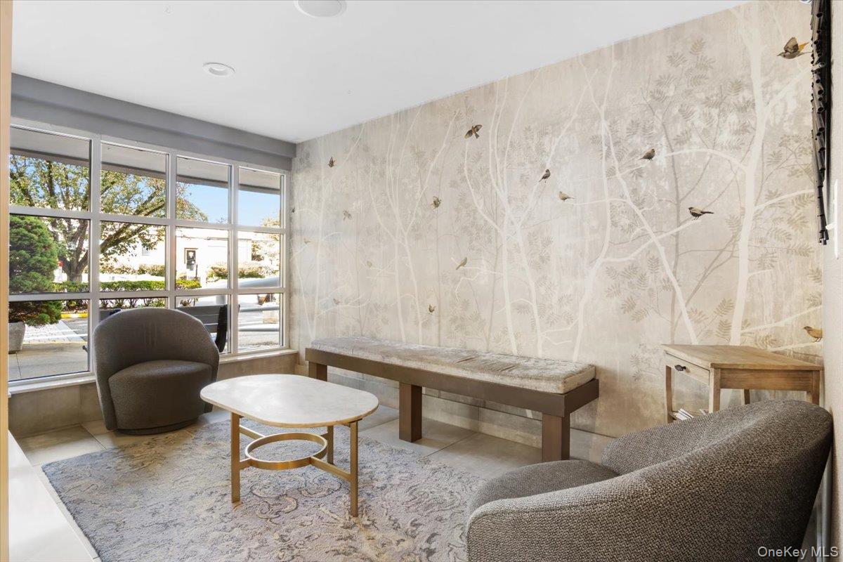 100 Cutter Mill Road, Unit 3F Great Neck, NY 11021 - Photo 5 of 33 a living room with furniture and a large window