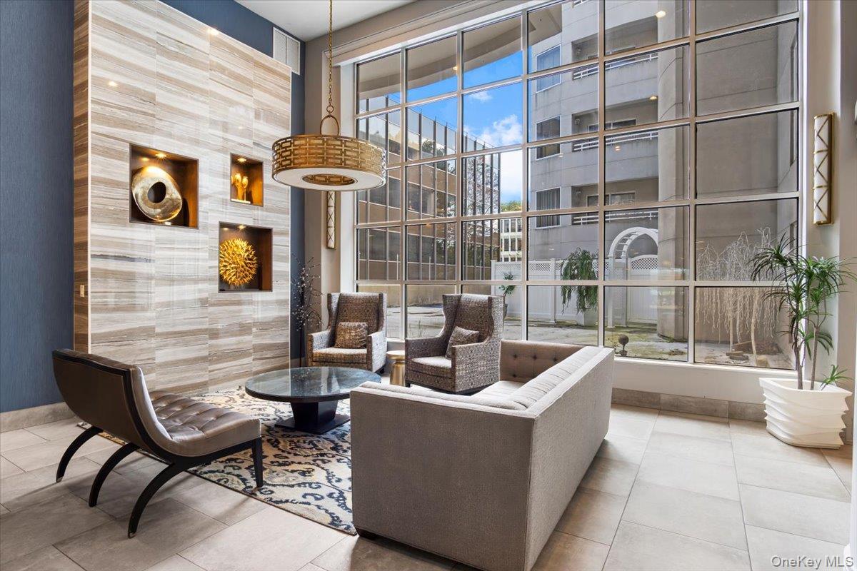 100 Cutter Mill Road, Unit 3F Great Neck, NY 11021 - Photo 7 of 33 a living room with furniture and a floor to ceiling window