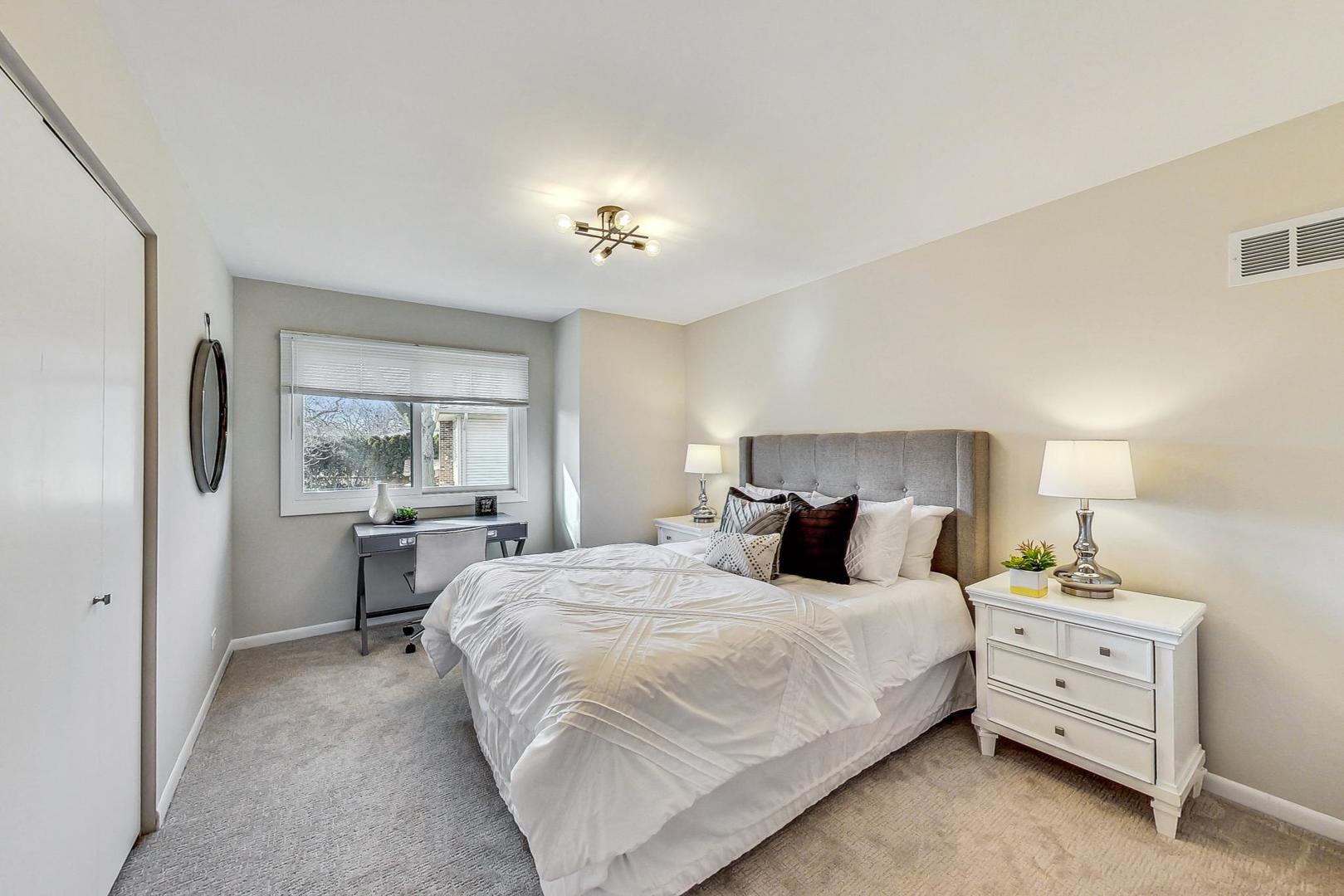 1724 Larkdale Road Northbrook, IL 60062 - Photo 21 of 31 a bedroom with a bed and dresser with mirror