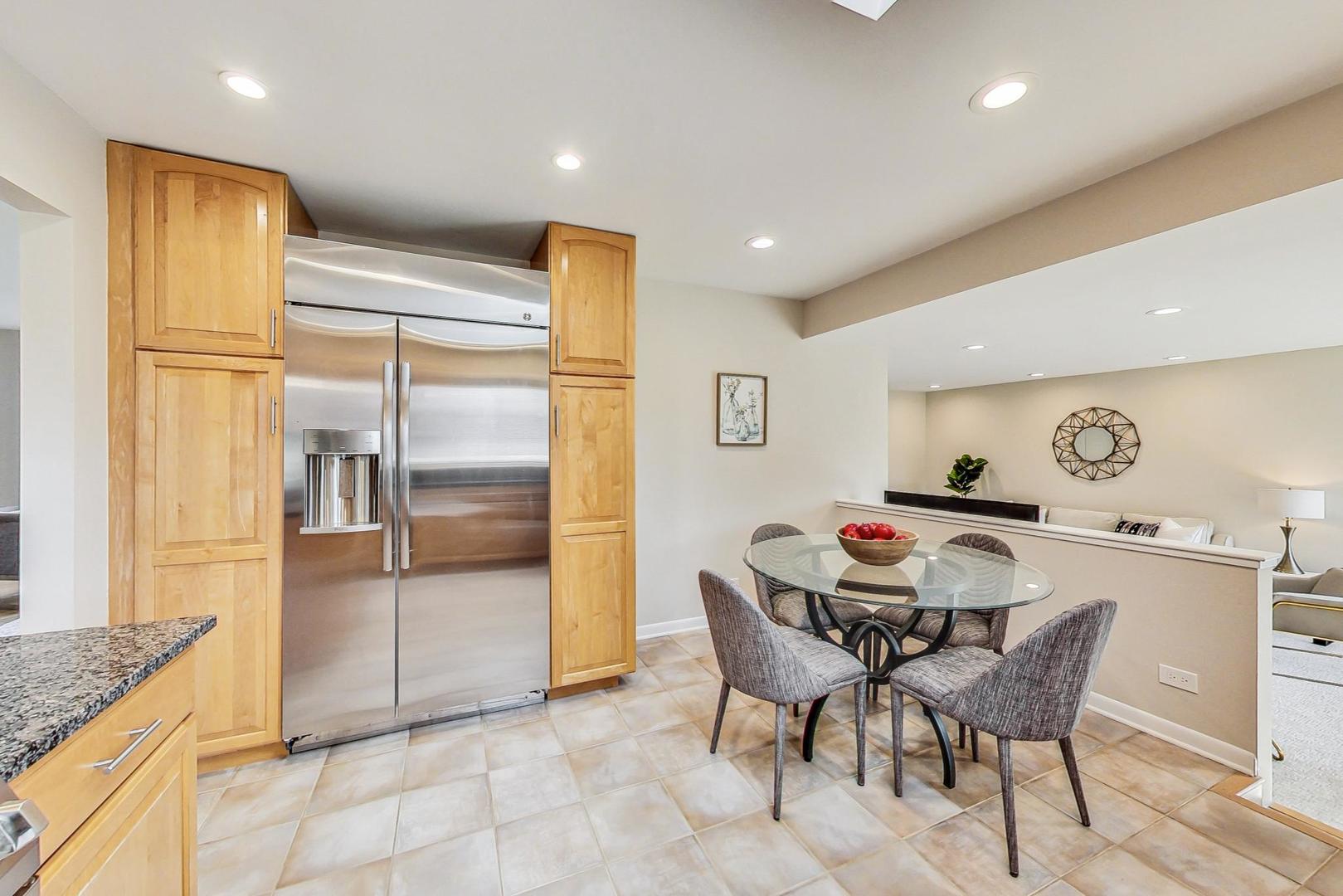 1724 Larkdale Road Northbrook, IL 60062 - Photo 8 of 31 a kitchen with stainless steel appliances kitchen island granite countertop a refrigerator and a sink